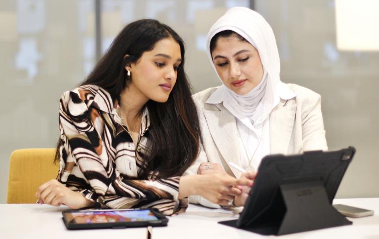 Kuwait university students study in library 